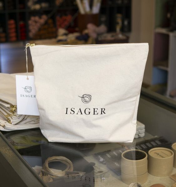 Isager Project Bag med dragkedja som står på en disk med varor